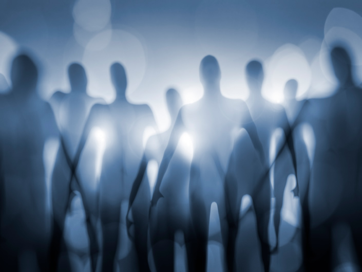 Out-of-focus alien shapes in front of a bright light