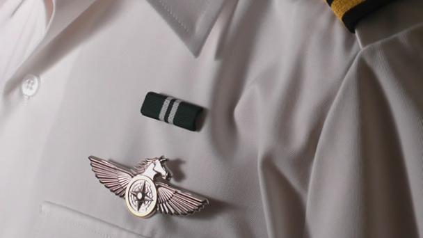 Dress uniform closeup of badge and ribbon