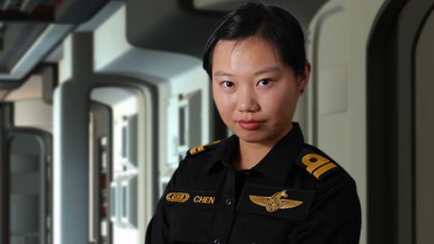 Lieutenant standing in starship corridor