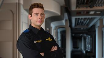 Petty officer standing in starship corridor