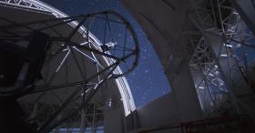 Large telescope pointed up at night sky